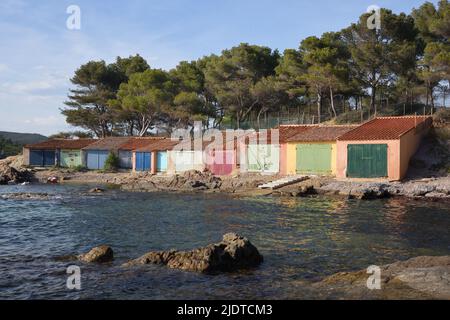 Colourful Old Boatsheds on the Shore near the Beach or Plage de Bregançon opposite Bregançon Fort & Island Bormes-les-Mimosas Var Provence france Stock Photo