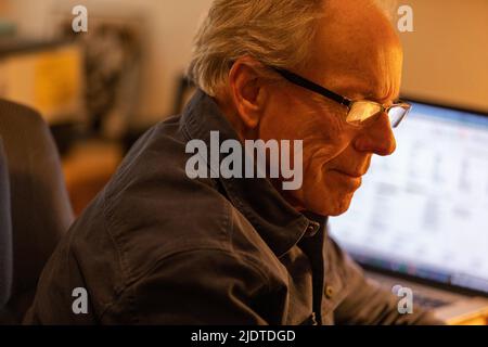 Senior man working at desk Stock Photo