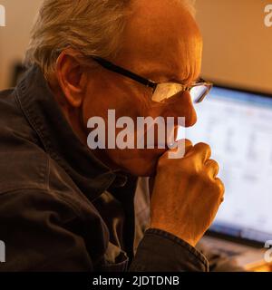 Senior man working at desk Stock Photo