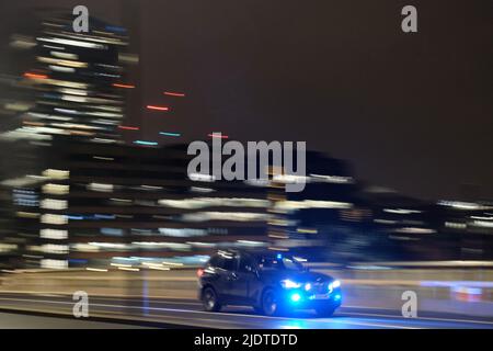 Police car speeding across London Bridge Stock Photo