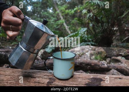 Pouring a cup of coffee in the Forest Stock Photo