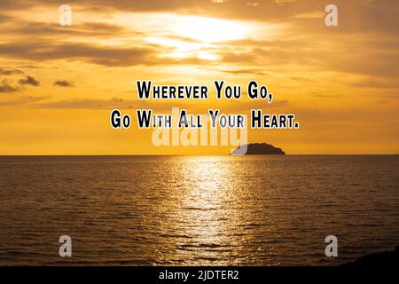 Motivational quote on sunset beach - Wherever you go, go with all your heart. Stock Photo