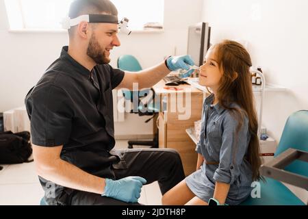 Rhinoscopy of child nose. Consultation with doctor. Children otolaryngologist examines child nose before procedure of endoscopy of nose Stock Photo