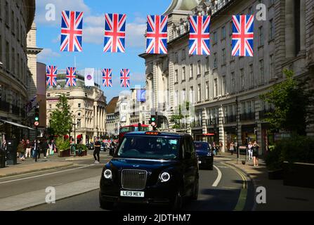 Looking towards Piccadilly Circus from Regent Street London England UK with Union Jacks Platinum Jubilee celebrations and a black taxi  June 2022 Stock Photo