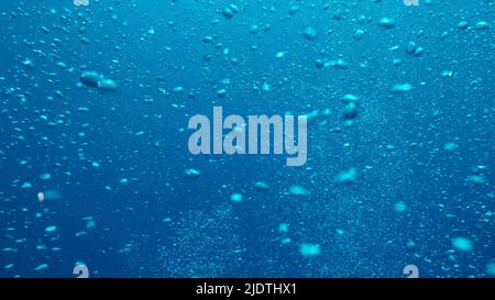 Air bubbles floating from sea bottom to the water surface. Air bubbles in the blue water. Mediterranean Sea, Cyprus Stock Photo
