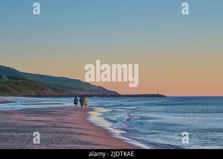 People out enjoying a beautiful summer evening sunset on Inverness Beach Cape Breton Nova Scotia. Stock Photo