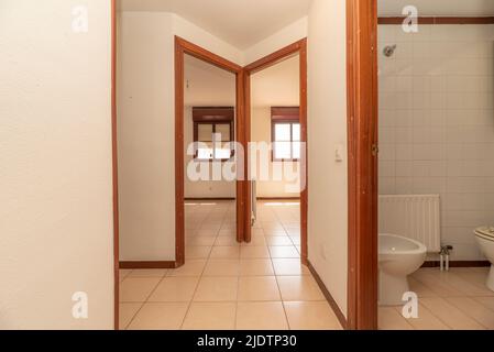 Distributor of a house with access to several rooms and a bathroom with white square tiled tiles Stock Photo