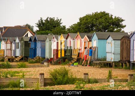 Colorful Beach huts along the shingles Beach of Whitstable England. Whitstable is a seaside town in South-west England in the Thames Estuary Stock Photo