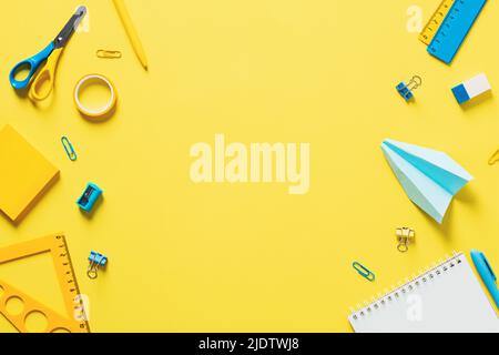 School supplies double border banner design. Top view yellow background with office stationery. Back to school concept. Stock Photo