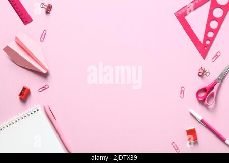 Pink office supplies on pink background. Flat lay, top view, minimal style. Back to school concept. Stock Photo
