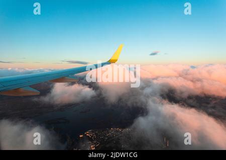 Stunning sunset from the window of the aircraft during the flight. Stock Photo