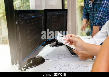 Programmers team working in a software developing. Developing programming and coding technologies. Website design. Cyber space concept. Stock Photo