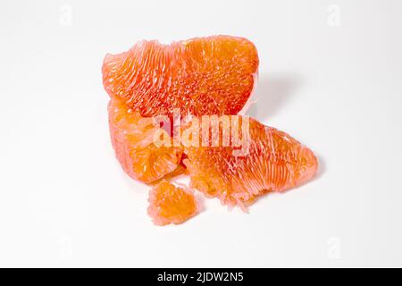 Red pomelo pulp isolated on white background. Natural source of vitamin C (antioxidants) and potassium. Citrus fruits. Stock Photo
