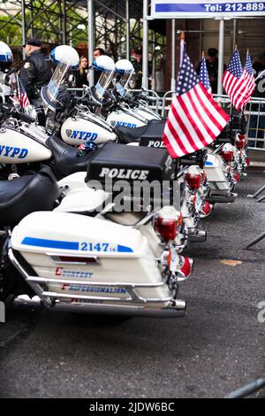 Manhattan, USA - 11. November 2021: NYPD Police Motorcycles parked in NYC with US Flags waving. New York Police Department bikes Stock Photo