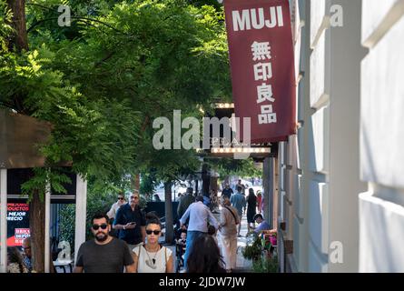 Pedestrians walk past the Japanese household and clothing retail company, Muji, store in Spain. Stock Photo