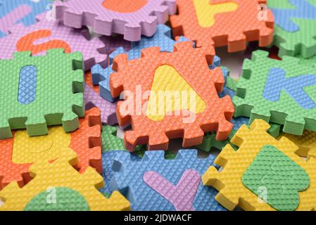 Close-up of colorful foam alphabet puzzle pieces Stock Photo