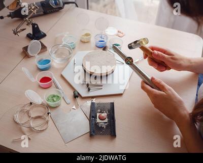 Lifestyle concept, work from home to reinvent your life - Jewelry designer workplace. Woman work with increase the ring size. Jeweler making accessori Stock Photo