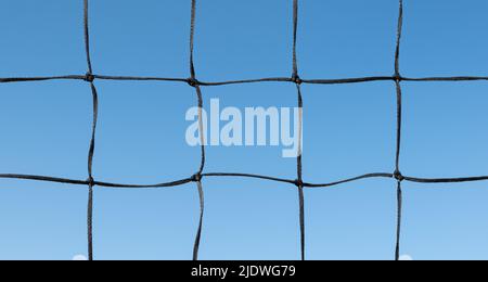 Volleyball net against blue sky background. Stock Photo