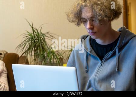 A young guy is being trained through a laptop. Remote communication Stock Photo