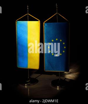 Flag of Ukraine and European Union standing together. Ukraine EU membership concept Stock Photo
