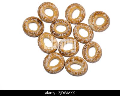 Isolate from dryers in glaze. A handful of bagels on a white background. Sweet food Stock Photo