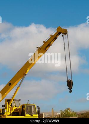 Crane on the blue sky of Aswan, Egypt used to carry granite blocks for the International symposium Stock Photo
