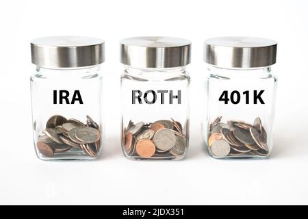 Jars with coins for retirement savings in Roth, 401K and IRA accounts Stock Photo