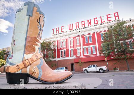 CHEYENNE, Wyoming - APRIL 27, 2018: Sign on top of The Wrangler in historic downtown Cheyenne Wyoming. The three story red-painted brick building domi Stock Photo