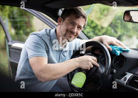 a man cleaning car interior Stock Photo