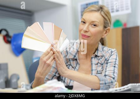 blonde focused designer working at her desk in creative office Stock Photo