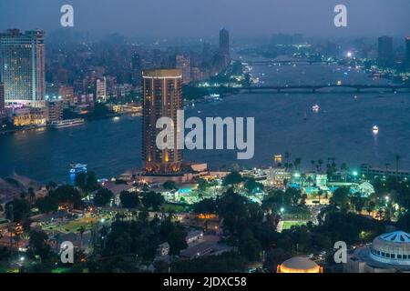 Egypt, Cairo, Gezira district with luxury hotel and sports courts at night Stock Photo