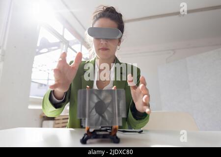 Female engineer developing new technology using virtual reality simulator Stock Photo