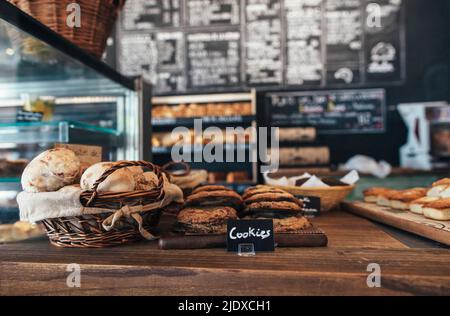 Fresh assortment of cookies and breads on table in bakery Stock Photo
