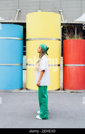 Young woman standing in front of concrete pipes Stock Photo