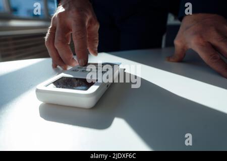 Hand of businessman using calculator on desk in office Stock Photo