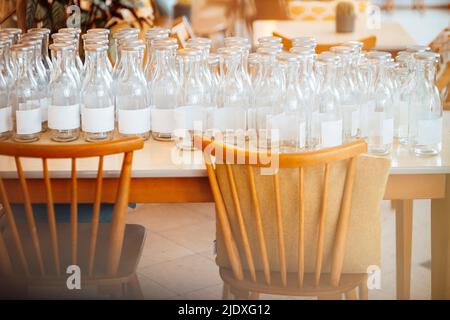 Empty glass bottles on table at cafe Stock Photo