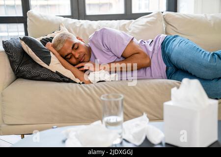 Young man sleeping on couch Stock Photo