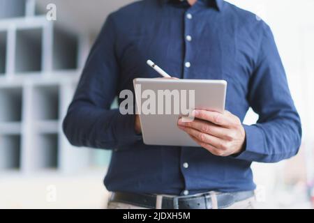 Hands of mature businessman using tablet PC Stock Photo