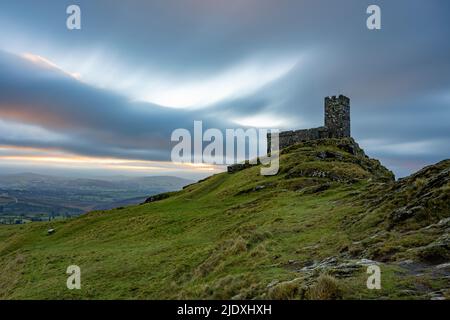 UK, England, Brentor, Cloudy sky over secluded Brentor Church at dusk Stock Photo