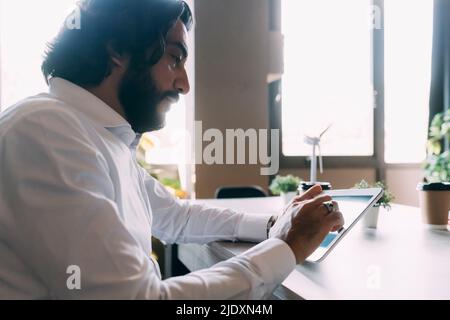 Mature businessman using tablet PC at office Stock Photo