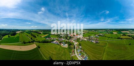 Germany, Bavaria, Kammeltal, Helicopter panorama of rural town surrounded by green fields in summer
