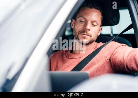 Man using laptop sitting in car Stock Photo