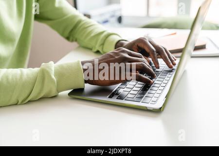 Young businessman typing on laptop at desk Stock Photo