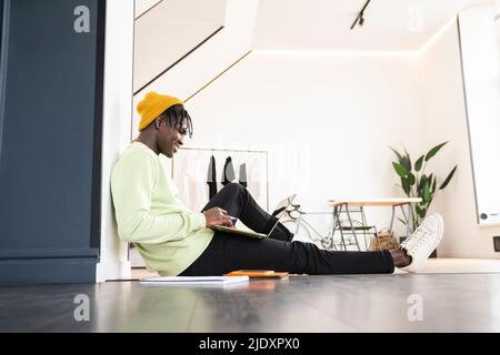 Young businessman working on laptop at home Stock Photo