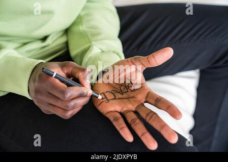 Man writing peace on palm of hand Stock Photo