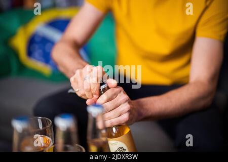 Hands of man opening beer bottle Stock Photo