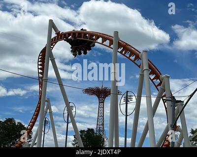 People ride the fast moving Thunderbolt roller coaster at Coney