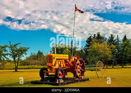 A retired antique Minneapolis Moline farm tractor sits as a decoration on a farmers lawn Stock Photo