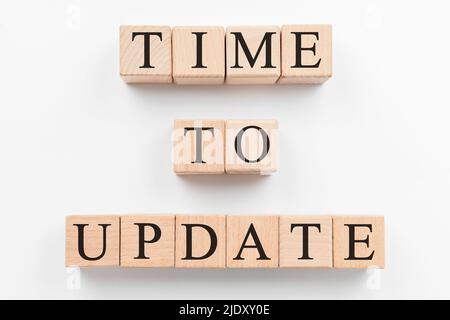 Text TIME TO UPDATE made of wooden cubes on white background Stock Photo