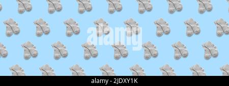 Many baby socks on light blue background. Pattern for design Stock Photo